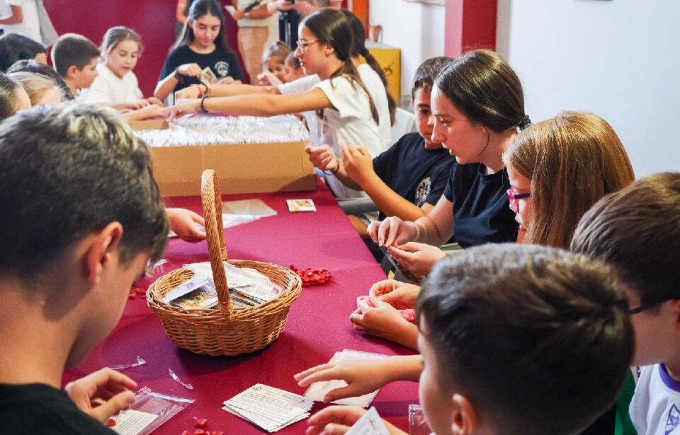 Los jóvenes de la hermandad realizan los corazones de cera.